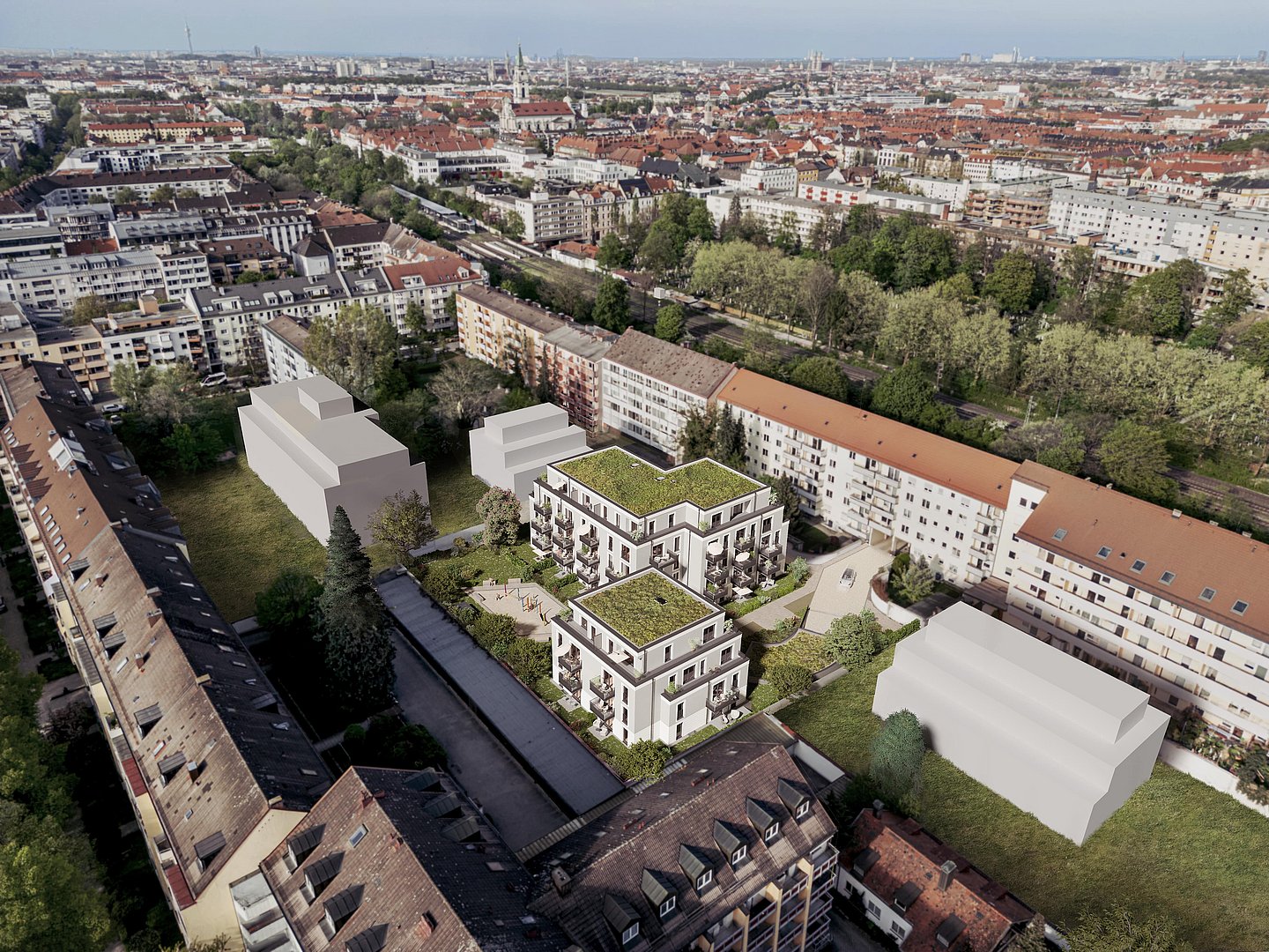 Blick von oben auf das Neubauprojekt mit begrünten Dächern